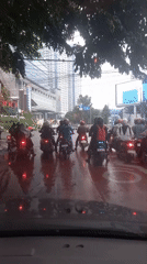 Wet Medan streets during rainy-day urban traffic