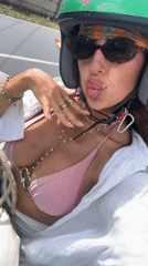 Woman takes selfies with motorcycle in Kuta Selatan