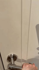 Woman opens door in Barcelona apartment or building