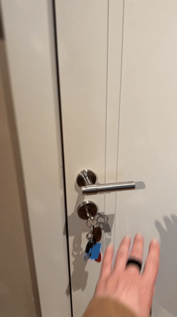 Woman opens door in Barcelona apartment or building