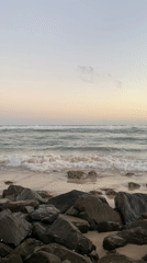 Waves crash on rocky Kathaluwa beach at sunset