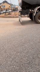Yellow three-wheeler travels with tanker truck in Bukuru
