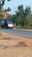 Giant effigy rides through Sri Bawono on a pickup truck