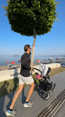 Man runs with baby stroller in Fethiye, Turkey