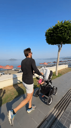 Man runs with baby stroller in Fethiye, Turkey