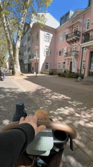 Parent pushes stroller through sunny Bad Kreuznach streets