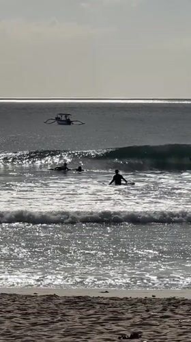 Busy morning on Kuta Beach — surfers, strollers, and selfies