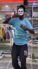 Masked man dances with phone inside store