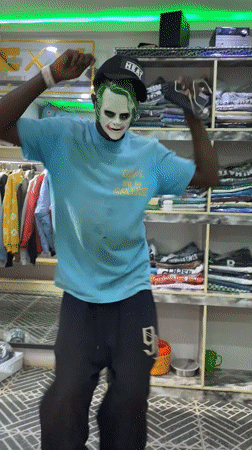 Masked man dances with phone inside store