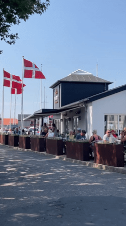 Sunny day at Juelsminde's waterfront, flags flying