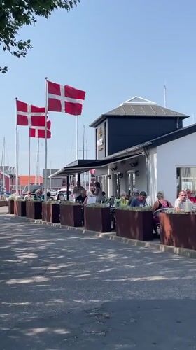 Sunny day at Juelsminde's waterfront, flags flying