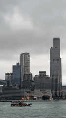 Hong Kong harbor and elevated road traffic captured under gray skies