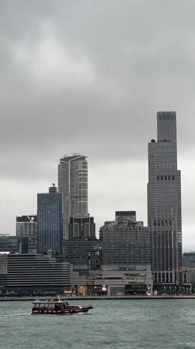 Hong Kong harbor and elevated road traffic captured under gray skies