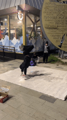 Street breakdancer performs evening routine on urban sidewalk