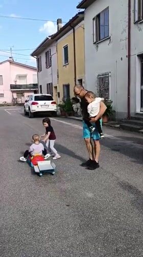 Family gathering with pets on Viadana street