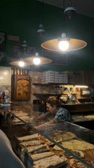 Pizza shop worker serves customers in Milan