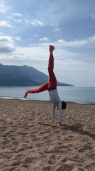 Woman performs beach gymnastics in Montenegro morning hours