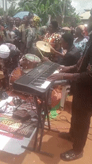 Village market bustles with vendors, shoppers, and live music