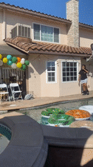 Backyard pool party setup with balloon arch and DJ in Cypress