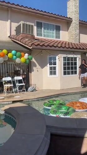 Backyard pool party setup with balloon arch and DJ in Cypress