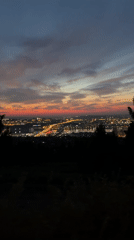 Dusk city views from a hilltop viewpoint, helmet and all