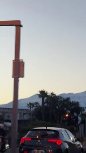 Mount Etna visible from Acireale streets during evening hours