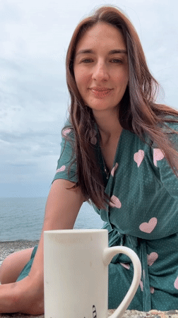 Woman enjoys morning drink on Sochi beach