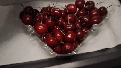 Roadside fruit and food spread near trucks in Savona