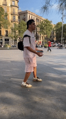 Skate tricks and street life in a sunny Barcelona plaza