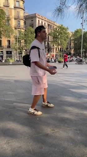 Skate tricks and street life in a sunny Barcelona plaza