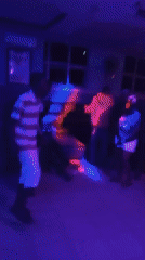 Nightclub patrons dance under colorful lights in Lokoja, Nigeria