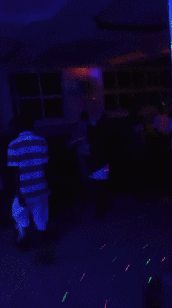 Nightclub patrons dance under colorful lights in Lokoja, Nigeria
