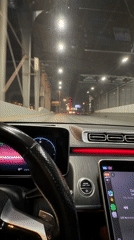 Driver navigates tunnel approaching Moscow cityscape at night
