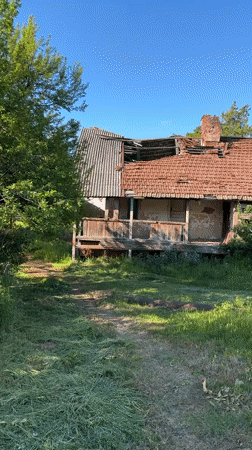 Abandoned house with collapsed roof documented in Skra, Georgia