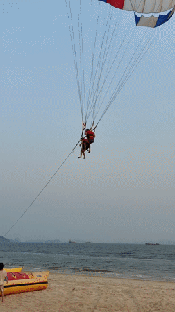 Father and daughter enjoy beach time near beached vessel