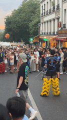 Street performance and a vivid sunset draw crowds in Paris