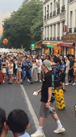 Street performance and a vivid sunset draw crowds in Paris