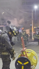 Firefighters battle urban blaze during nighttime operations