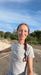 Woman documents outdoor afternoon with cats in rural Ukraine