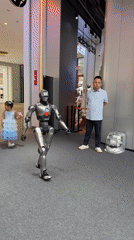 Child hugs humanoid robot in public Futian District gathering
