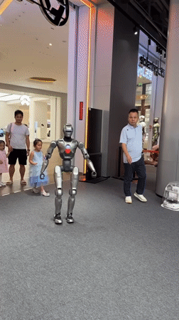 Child hugs humanoid robot in public Futian District gathering