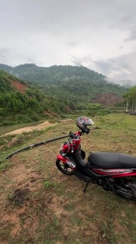 Motorcycle rest stop captured along river in Vietnamese countryside