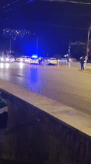 Police block Sofia intersection with multiple vehicles, pedestrians present