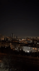 Nighttime cityscape captured in Tehran showing illuminated buildings