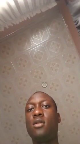 Man photographed from below indoors in Rido, Nigeria