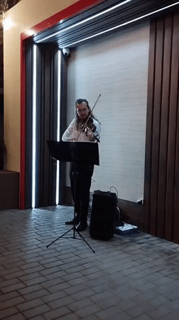Outdoor violin performance at a modern venue in Bender, Moldova