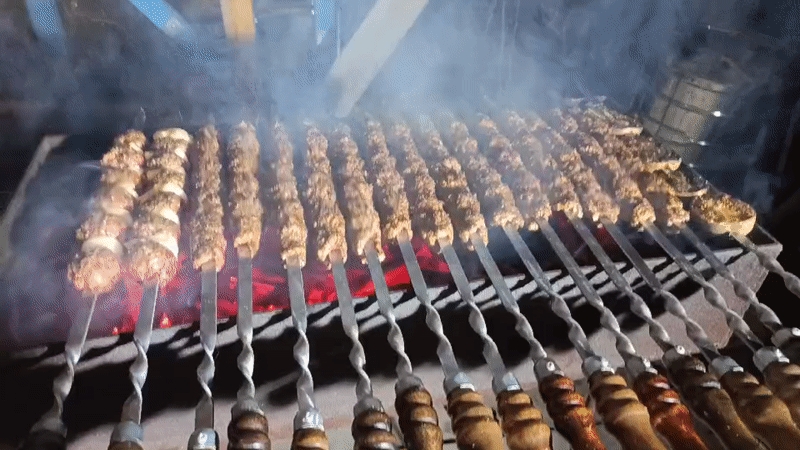 Evening kebab grilling session documented in Nizhnevartovsk, Russia