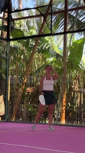 Woman plays padel on pink court in General Luna
