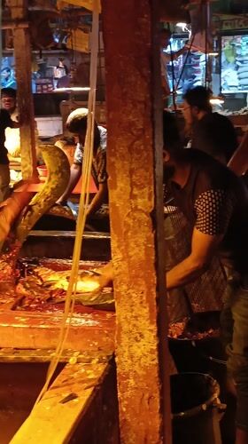 Fish vendors conduct regular business at Dhaka market
