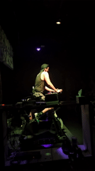 Man performs in dimly lit venue in Puebla